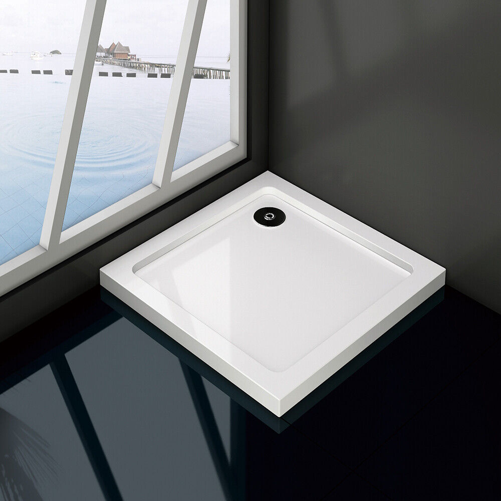 Slimline square rectangle stone shower tray in a bathroom setting, predominantly white in color with a visible waste hole position.